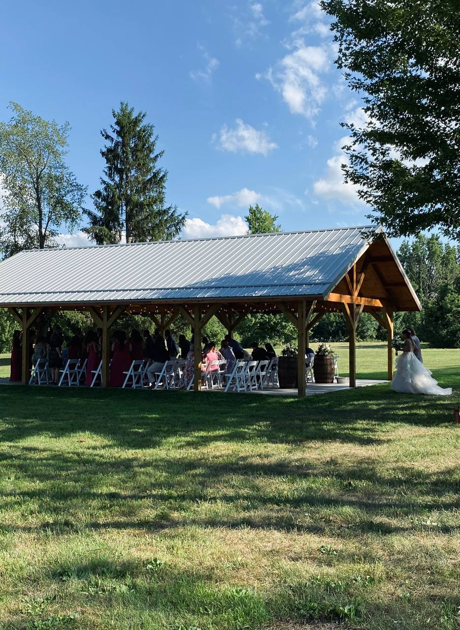 Bride in a full tulle gown arriving at the pavilion ceremony