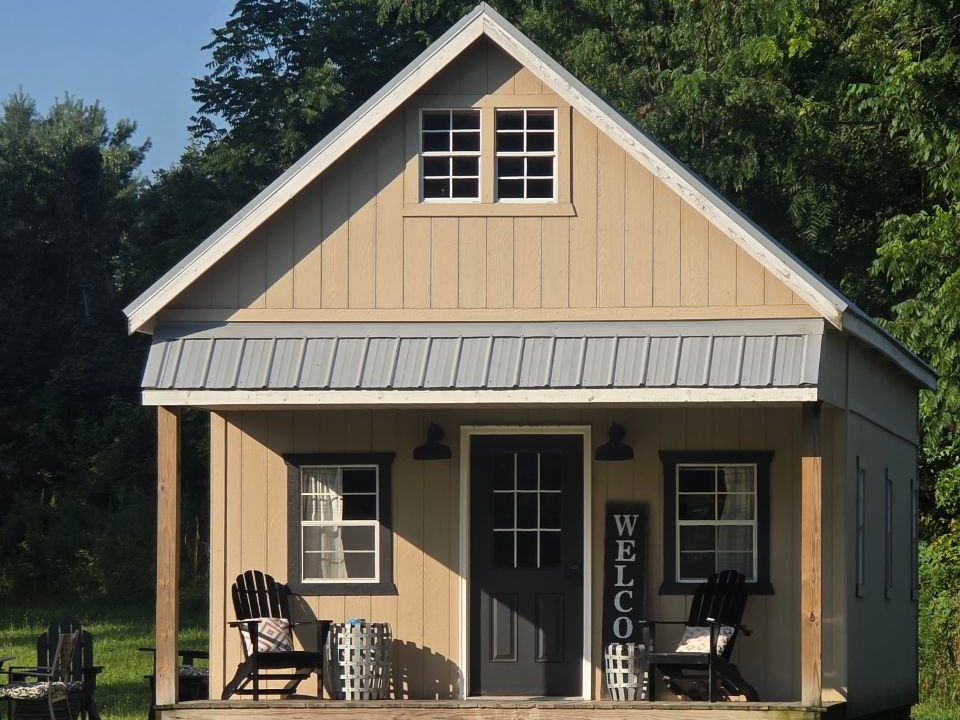 Charming Amish-built cottage with a covered front porch and rocking chairs